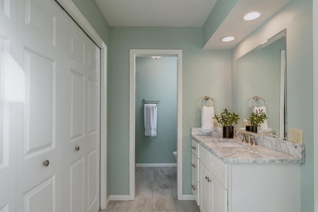 5402 Comanche Way, Madison, WI 53704 - bathroom with vanity, baseboards, toilet, and recessed lighting