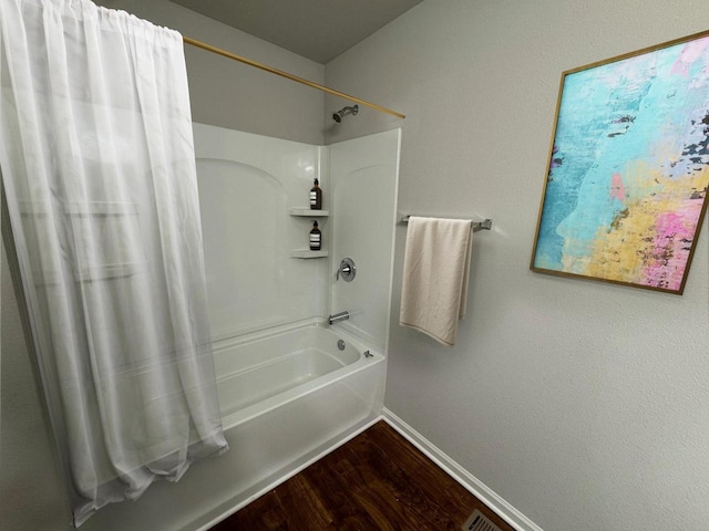 708 E Maple Beach Dr, Edgerton, WI 53534 - bathroom featuring baseboards, wood finished floors, and shower / bath combination with curtain