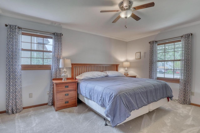 bedroom with carpet, baseboards, ornamental molding, and ceiling fan