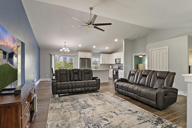 2130 90th St, Sturtevant, WI 53177 - living area featuring a ceiling fan, vaulted ceiling, dark wood finished floors, a chandelier, and recessed lighting