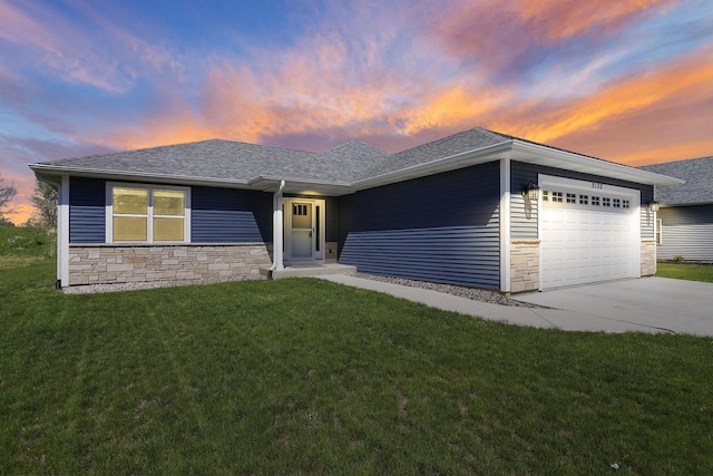 2130 90th St, Sturtevant, WI 53177 - view of front of house featuring stone siding, an attached garage, and a front yard