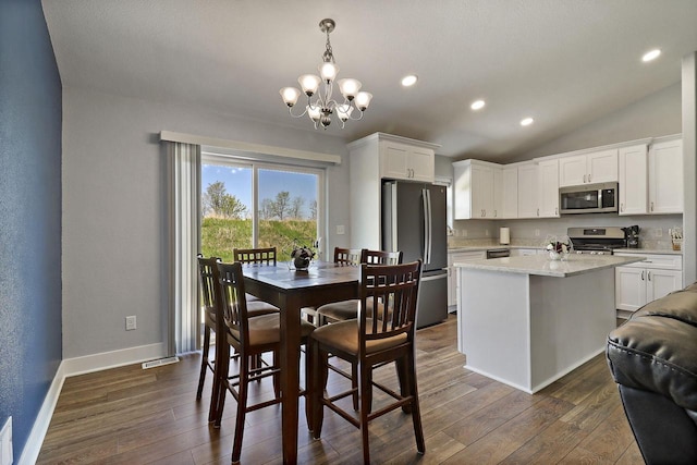 2130 90th St, Sturtevant, WI 53177 - dining room featuring dark wood finished floors, a chandelier, baseboards, lofted ceiling, and recessed lighting