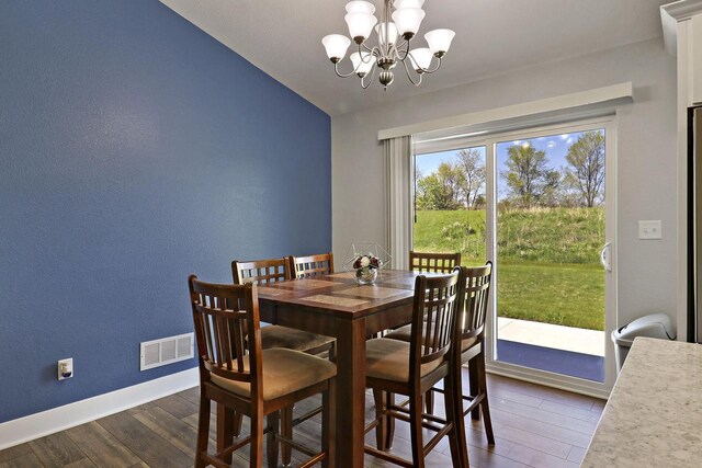 2130 90th St, Sturtevant, WI 53177 - dining room featuring dark wood finished floors, a chandelier, baseboards, and vaulted ceiling