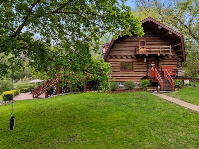 644 County Highway K, Hartford, WI 53027 - cabin with stairway, a front yard, and log exterior