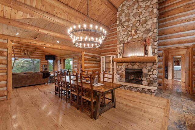 644 County Highway K, Hartford, WI 53027 - dining room featuring wooden ceiling, rustic walls, beam ceiling, a fireplace, and a chandelier