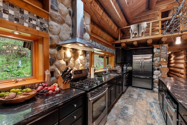 644 County Highway K, Hartford, WI 53027 - kitchen with stainless steel appliances, exhaust hood, a sink, dark cabinetry, and high vaulted ceiling