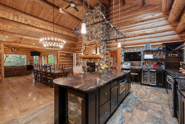 644 County Highway K, Hartford, WI 53027 - kitchen featuring beverage cooler, open floor plan, rustic walls, stainless steel gas range oven, and wood ceiling