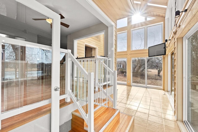 staircase featuring ceiling fan