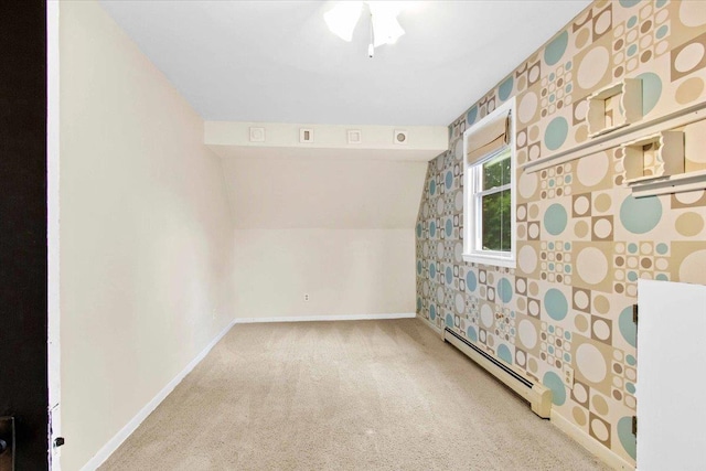 330 1st St, Port Edwards, WI 54469 - carpeted spare room featuring a baseboard heating unit, baseboards, and vaulted ceiling