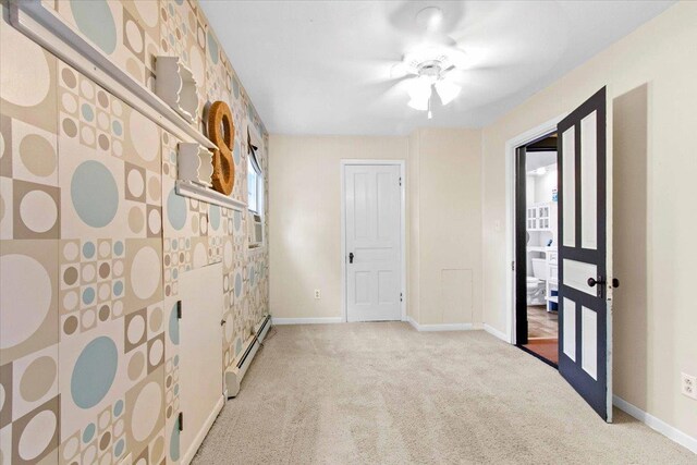330 1st St, Port Edwards, WI 54469 - unfurnished bedroom with baseboard heating, carpet floors, baseboards, and a ceiling fan