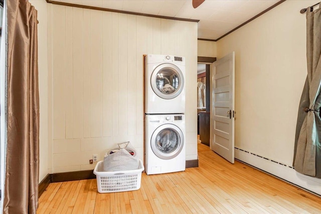 330 1st St, Port Edwards, WI 54469 - washroom featuring stacked washer / drying machine, baseboard heating, hardwood / wood-style flooring, and ornamental molding