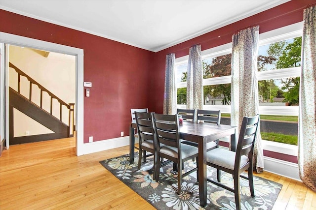 330 1st St, Port Edwards, WI 54469 - dining area with light wood-style flooring, stairway, baseboards, and ornamental molding