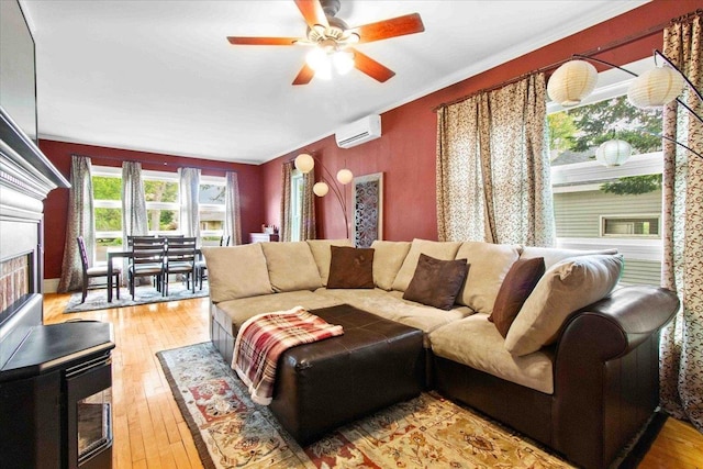 330 1st St, Port Edwards, WI 54469 - living room featuring an AC wall unit, wood-type flooring, ceiling fan, and a fireplace