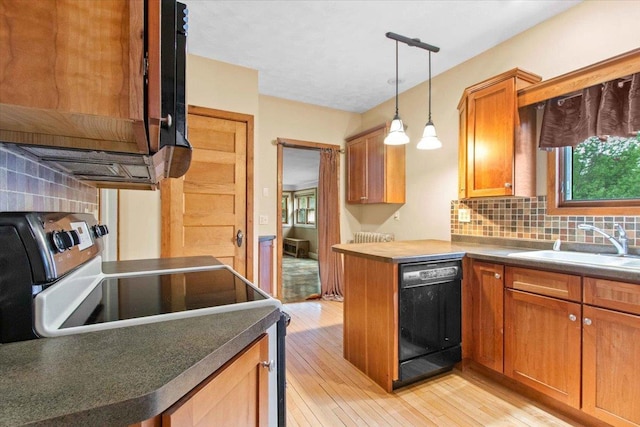 330 1st St, Port Edwards, WI 54469 - kitchen with dishwasher, tasteful backsplash, light wood-style flooring, and decorative light fixtures
