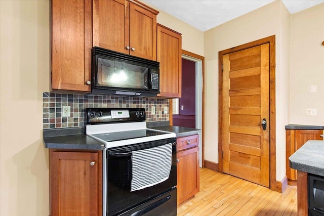 330 1st St, Port Edwards, WI 54469 - kitchen featuring black microwave, electric stove, backsplash, and light wood-type flooring
