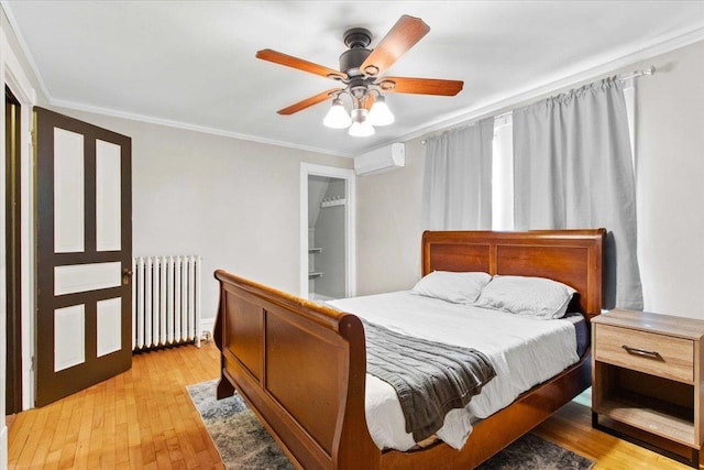 330 1st St, Port Edwards, WI 54469 - bedroom featuring radiator heating unit, crown molding, light wood-type flooring, a wall mounted air conditioner, and a ceiling fan