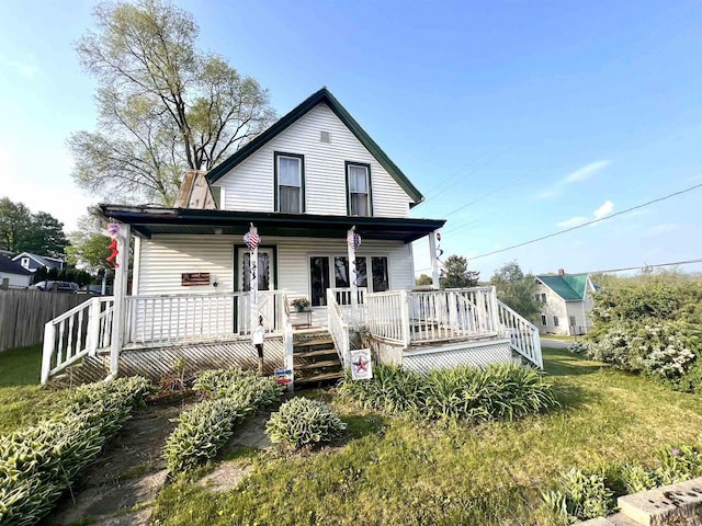 view of front facade with fence and a porch