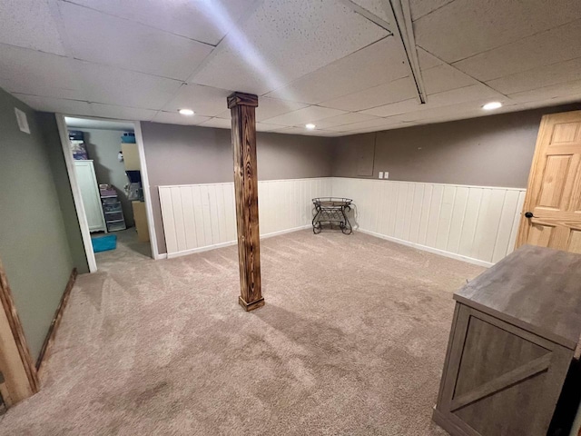 finished basement featuring carpet, wainscoting, a drop ceiling, and recessed lighting