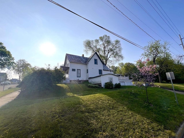 view of property exterior featuring a lawn