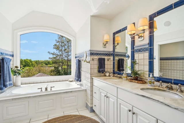 W8849 Deer Run Trl, Cambridge, WI 53523 - bathroom with tile walls, healthy amount of natural light, double vanity, a bath, and vaulted ceiling