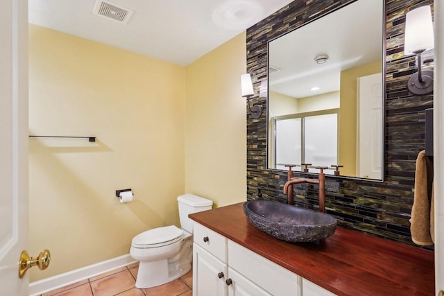 W8849 Deer Run Trl, Cambridge, WI 53523 - bathroom with tile patterned flooring, decorative backsplash, toilet, vanity, and baseboards