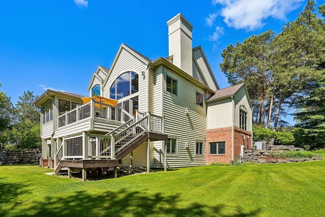 W8849 Deer Run Trl, Cambridge, WI 53523 - rear view of property with a sunroom, stairs, a chimney, a lawn, and a deck