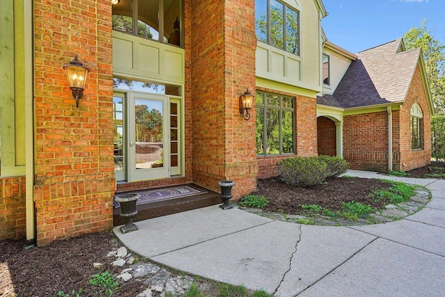 W8849 Deer Run Trl, Cambridge, WI 53523 - doorway to property featuring roof with shingles and brick siding