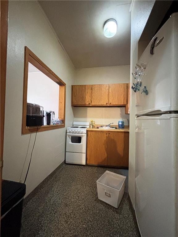 111 Arlington Ave Unit 1-12, Cameron, WI 54822 - kitchen with white appliances, brown cabinetry, a sink, and light countertops