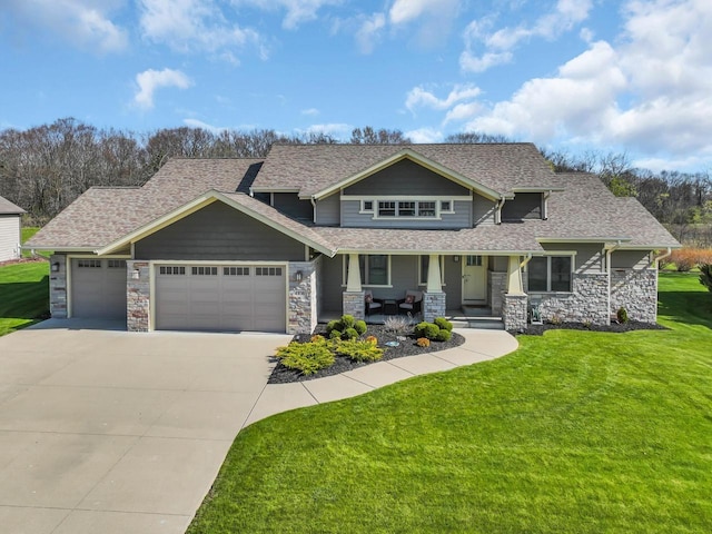 4938 Copper Leaf Blvd, Mount Pleasant, WI 53403 - craftsman-style house with covered porch, a garage, stone siding, concrete driveway, and a front yard