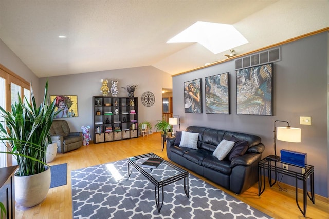 1502 Marquardt Rd, Wausau, WI 54403 - living area with a skylight, vaulted ceiling, and wood finished floors