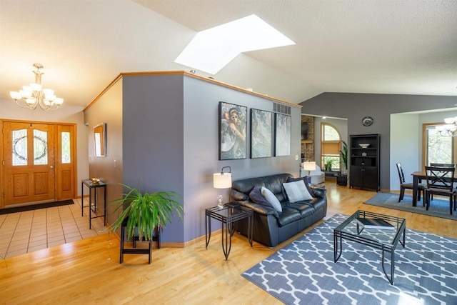 1502 Marquardt Rd, Wausau, WI 54403 - living room with a chandelier, vaulted ceiling, a skylight, wood finished floors, and baseboards