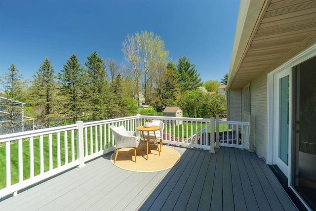 1502 Marquardt Rd, Wausau, WI 54403 - deck with a storage unit, an outdoor structure, and a lawn