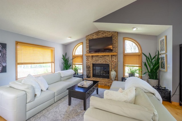 1502 Marquardt Rd, Wausau, WI 54403 - living room with lofted ceiling, a fireplace, and wood finished floors