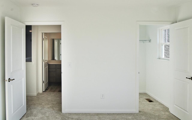 4004 Banbury St, Windsor, WI 53598 - unfurnished bedroom with light carpet, a spacious closet, a closet, and baseboards