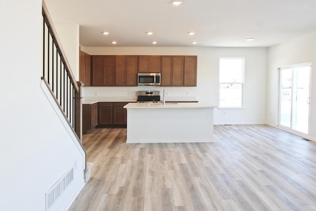 4004 Banbury St, Windsor, WI 53598 - kitchen with stainless steel appliances, light countertops, recessed lighting, light wood finished floors, and an island with sink
