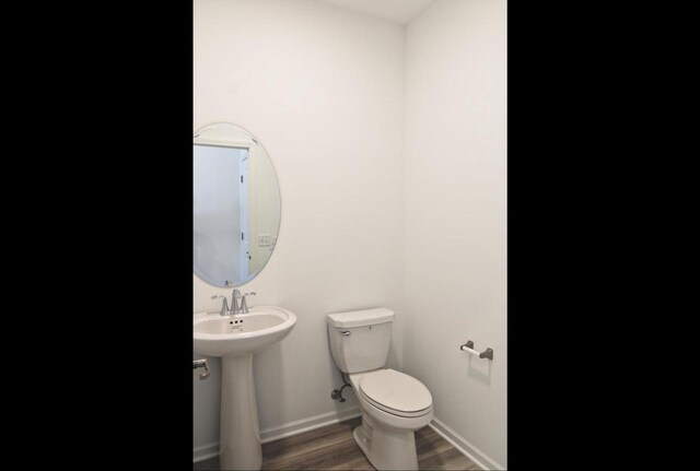 4004 Banbury St, Windsor, WI 53598 - half bath featuring toilet, wood finished floors, baseboards, and a sink