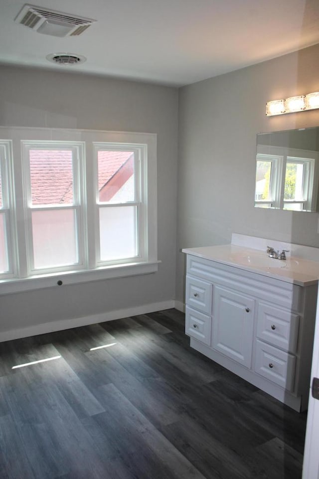 2909 N Farwell Ave, Milwaukee, WI 53211 - bathroom featuring plenty of natural light, vanity, wood finished floors, and baseboards
