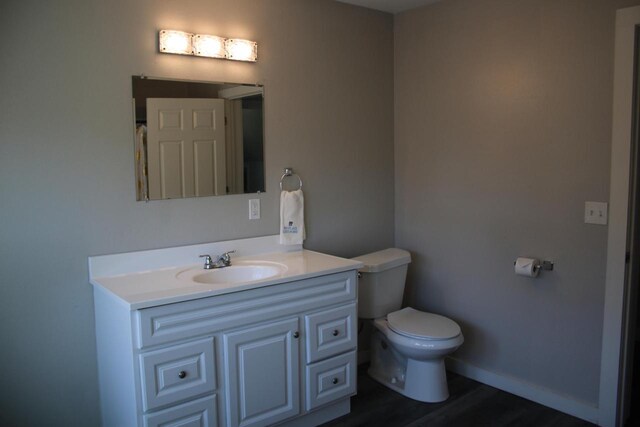 2909 N Farwell Ave, Milwaukee, WI 53211 - bathroom featuring vanity, wood finished floors, toilet, and baseboards