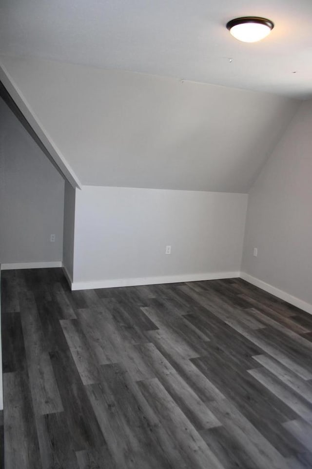 2909 N Farwell Ave, Milwaukee, WI 53211 - bonus room with vaulted ceiling, dark wood-style flooring, and baseboards
