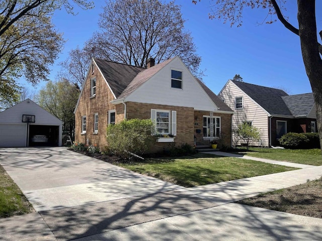 501 E Alice St, Appleton, WI 54911 - view of front of house with a detached garage, an outbuilding, a front lawn, brick siding, and a chimney
