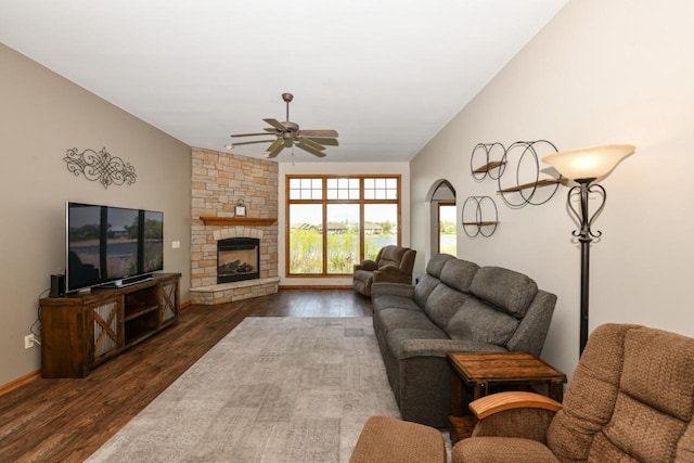 6454 Heritage Ave, Mount Pleasant, WI 53406 - living room featuring a ceiling fan, dark wood-style floors, a stone fireplace, and baseboards