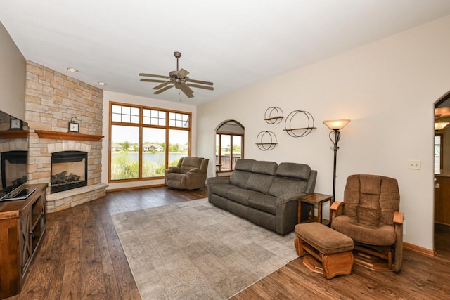 6454 Heritage Ave, Mount Pleasant, WI 53406 - living room featuring ceiling fan, dark wood-style floors, a fireplace, and arched walkways