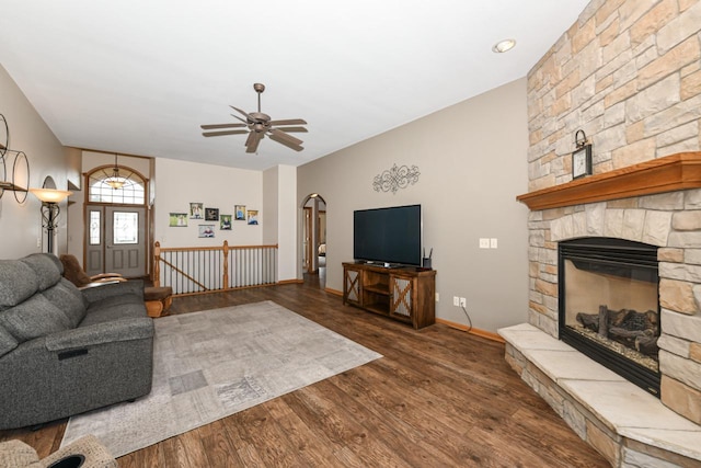 6454 Heritage Ave, Mount Pleasant, WI 53406 - living room featuring arched walkways, ceiling fan, wood finished floors, a stone fireplace, and baseboards