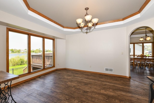 6454 Heritage Ave, Mount Pleasant, WI 53406 - unfurnished dining area featuring a chandelier, a tray ceiling, crown molding, arched walkways, and baseboards
