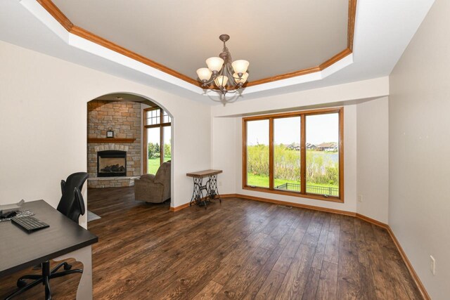 6454 Heritage Ave, Mount Pleasant, WI 53406 - office with a raised ceiling, a stone fireplace, a chandelier, dark wood-type flooring, and baseboards