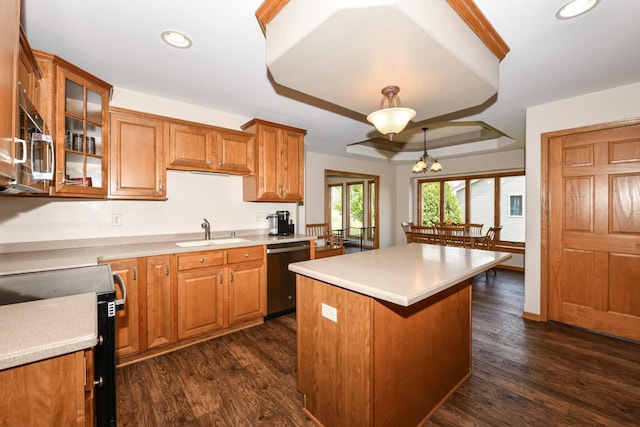6454 Heritage Ave, Mount Pleasant, WI 53406 - kitchen with stainless steel appliances, a sink, brown cabinets, a kitchen island, and light countertops