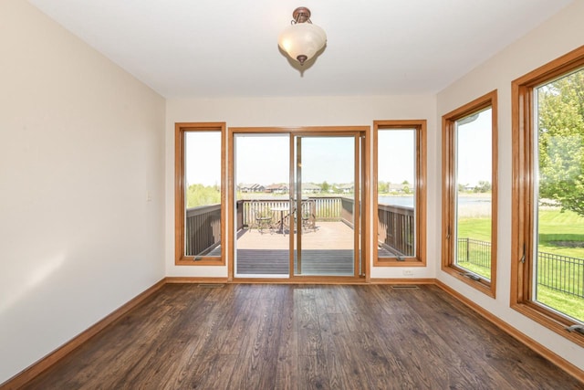 6454 Heritage Ave, Mount Pleasant, WI 53406 - unfurnished sunroom featuring baseboards, wood finished floors, and a water view