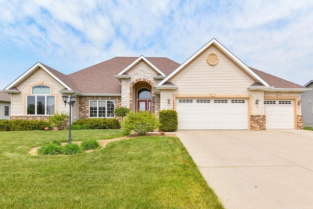 6454 Heritage Ave, Mount Pleasant, WI 53406 - view of front of home with a garage, concrete driveway, stone siding, a front lawn, and roof with shingles