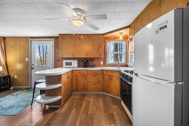 229 Bay Rd, Peshtigo, WI 54147 - kitchen featuring white appliances, open shelves, a peninsula, plenty of natural light, and wooden walls