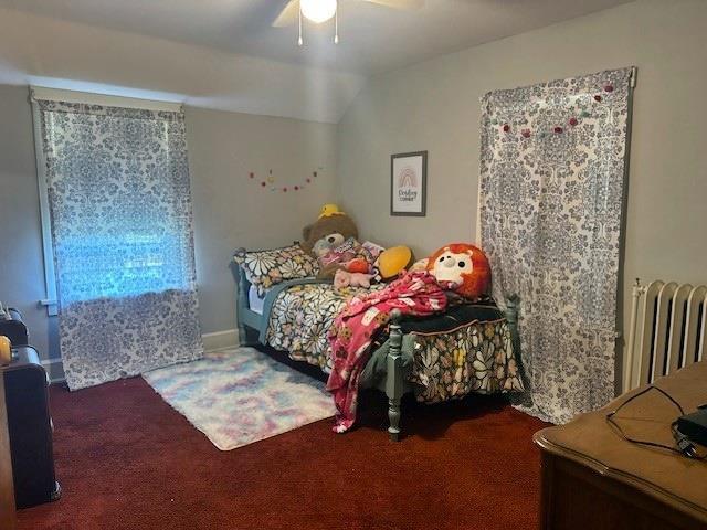 110 Hewett St, Neillsville, WI 54456 - bedroom featuring carpet flooring, radiator heating unit, ceiling fan, and vaulted ceiling